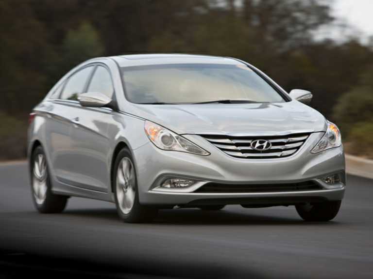 Silver 2013 Hyundai Sonata in motion with trees in background