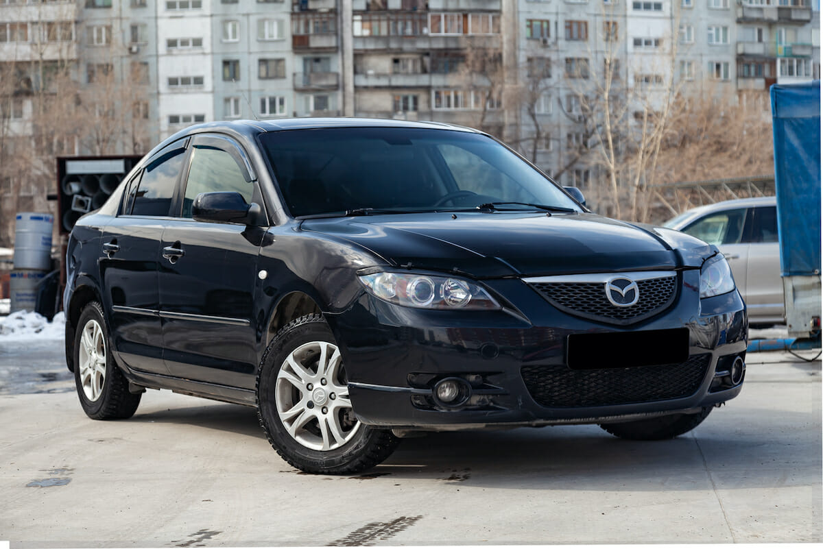Mazda3 2008 year front view with dark gray interior in excellent condition in a parking space among other cars
